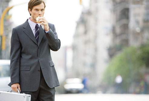 photolibrary_rf_photo_of_man_eating_while_walking