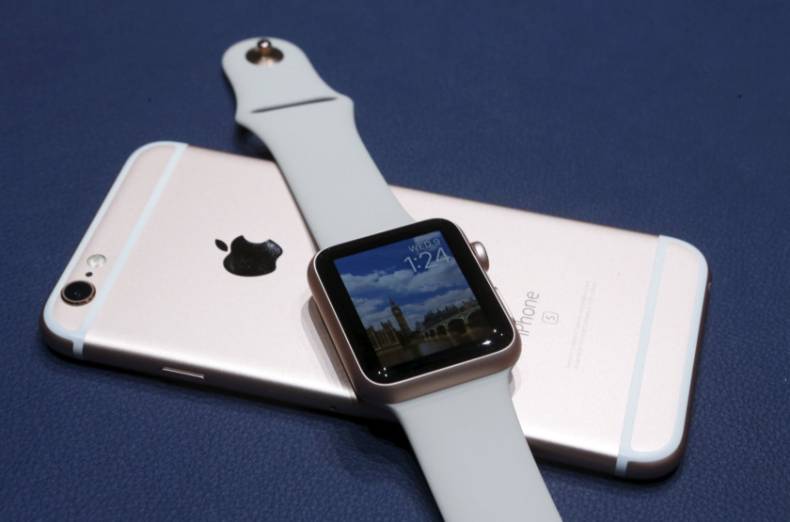 A new Apple iPhone 6S and Apple Watch in the new matching rose gold color are displayed during an Apple media event in San Francisco, California