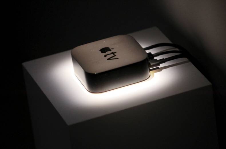 The new Apple TV is displayed during an Apple media event in San Francisco. The new TV box is a significant upgrade from older versions and it has a more powerful processor and updated software for running Internet apps and games on TVs, along with streaming music and video.
